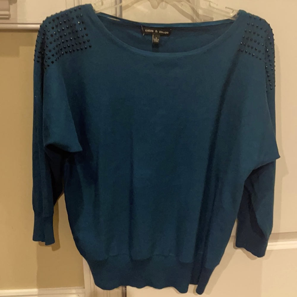 This blouse is 3/4 sleeve and is rayon and polyester material